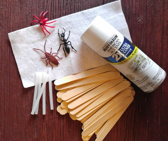 paint, bugs, craft sticks, felt, glue sticks supplies for picket fence