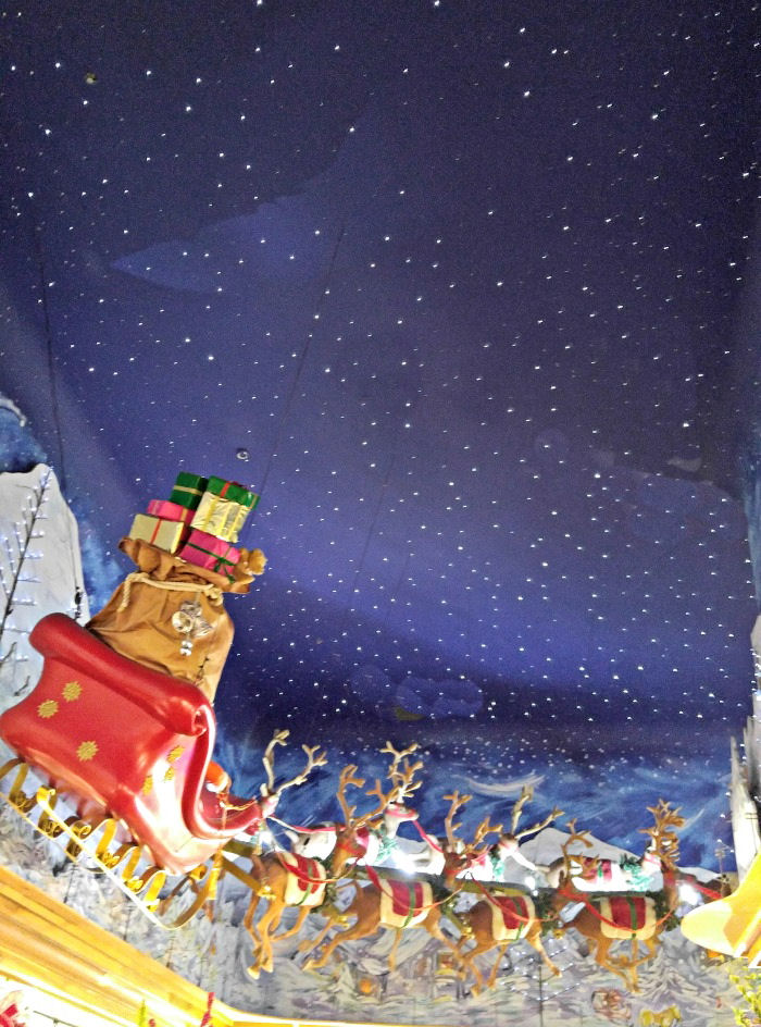 Christmas sleigh in a starry sky. Ceiling in one room of The Incredible Christmas Place