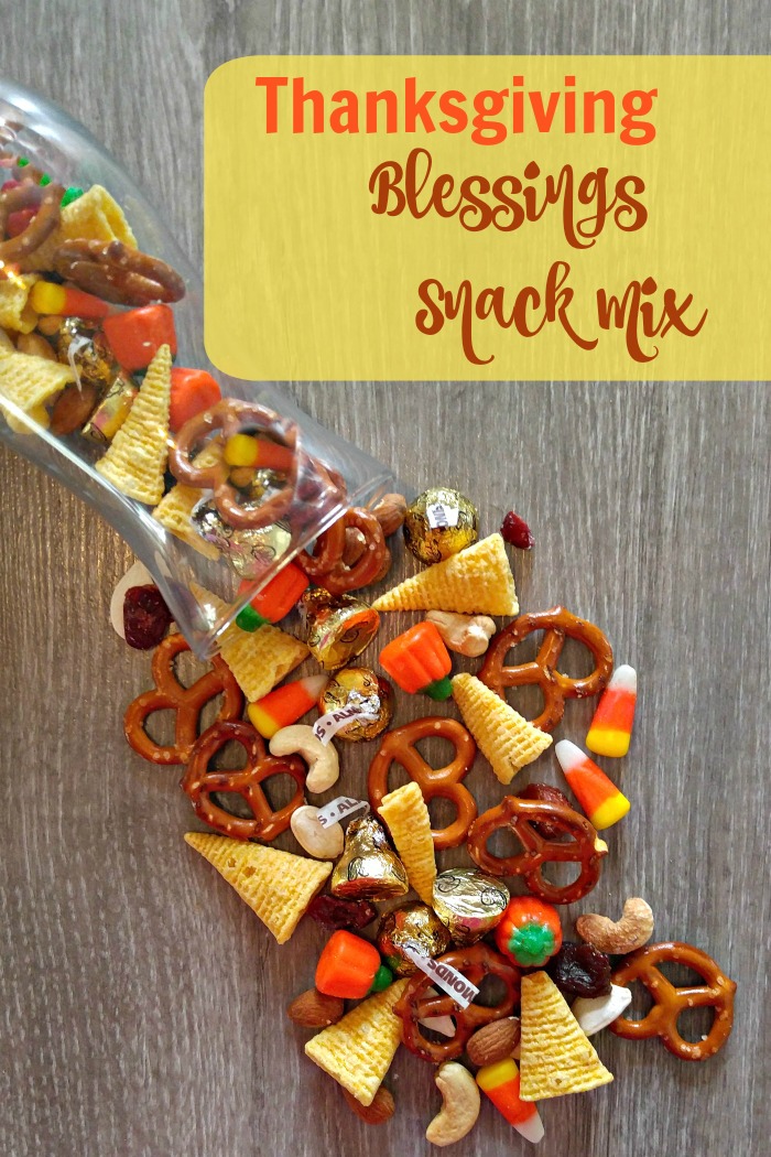 Tasty trail mix, pouring out of a bag with words reading Thanksgiving Blessings Snack Mix.