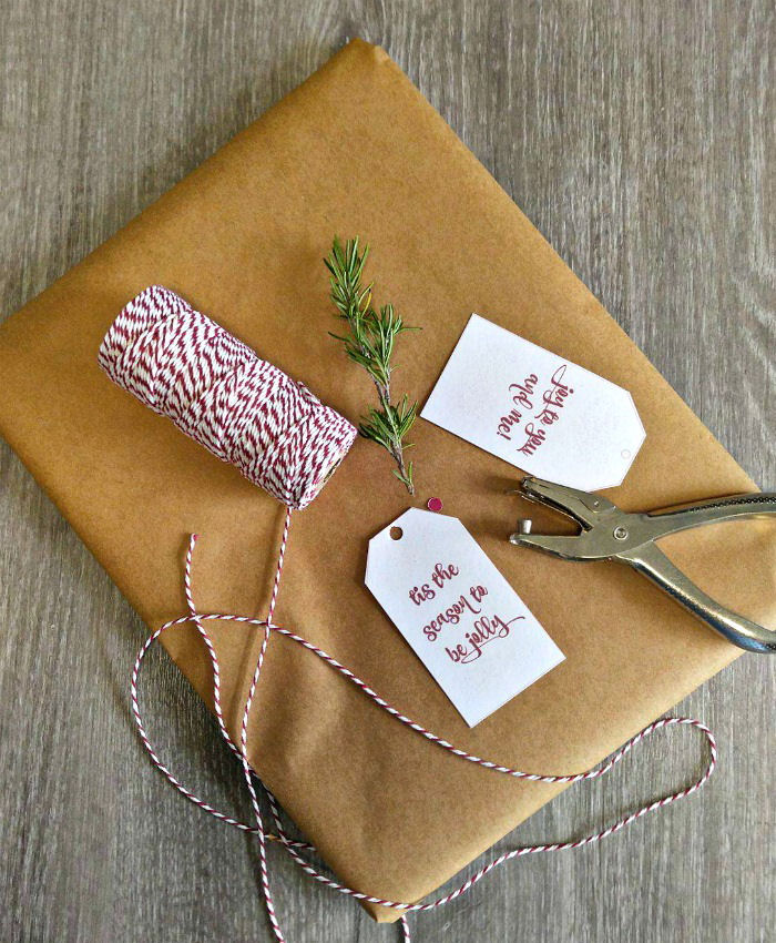 Rosemary, butchers twine, hole punch and Christmas labels Butchers twine and manila wrapping paper