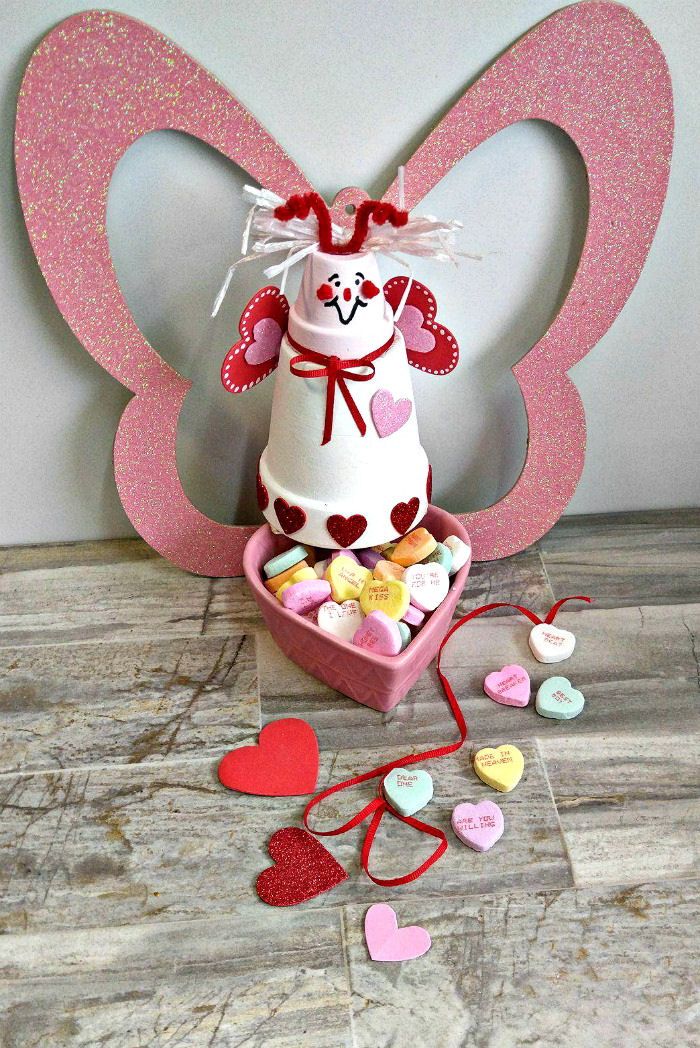Love bug candy dish made from clay pots This Clay pot love bug candy dish is the perfect way to display conversation hearts. It is easy to make and takes about a hour to make. #lovebug #conversationhearts