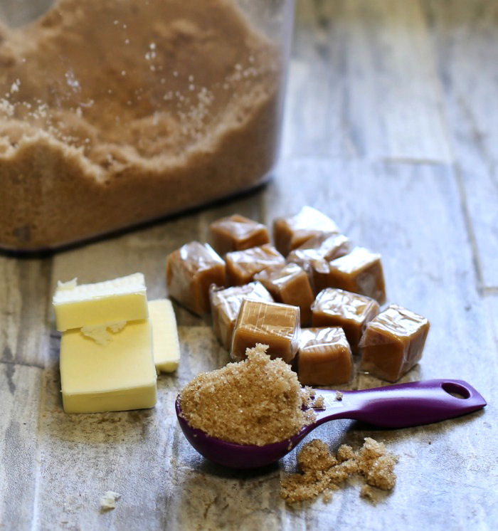 Butter, brown sugar and caramels. the ingredients for making blondies (butterscotch with butter and brown sugar) on a wooden surface.