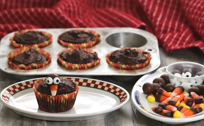 Turkey face Turkey face on a chocolate cupcake near more cupcakes and candy.