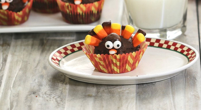 turkey feathers made from candy corn Chocolate cupcake in a fancy liner made into the shape of a turkey.
