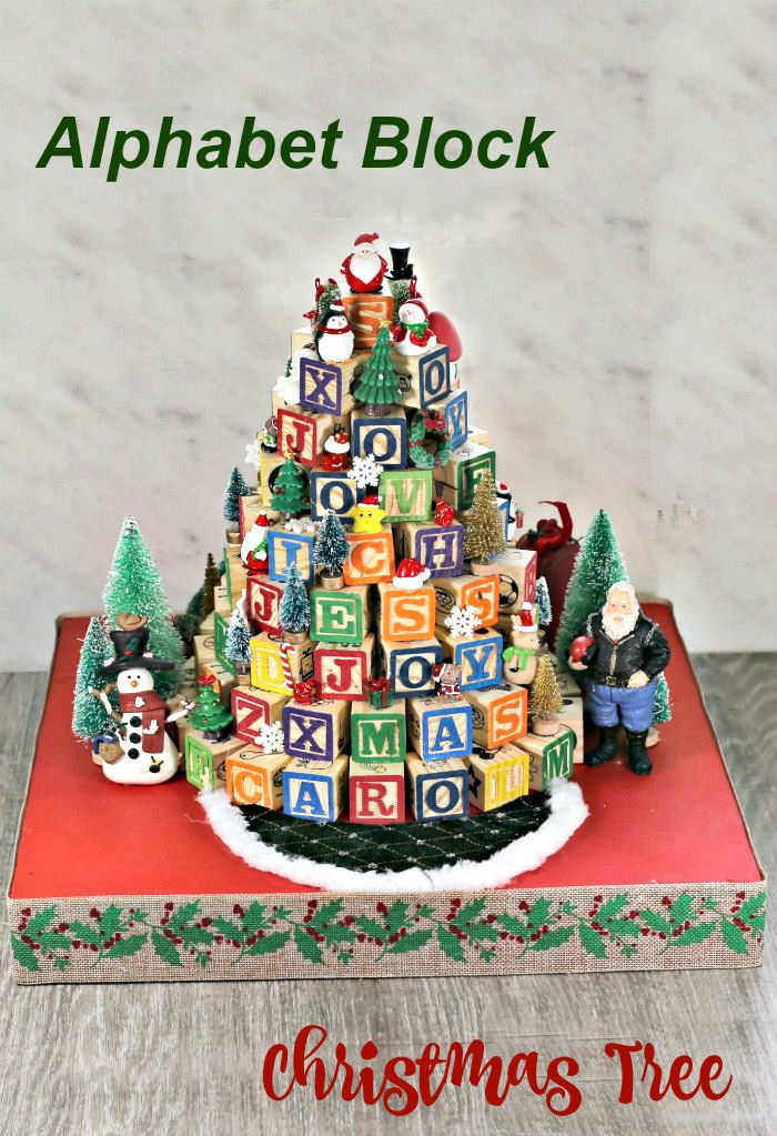 Wooden ABC blocks in the shape of a tree with words reading "Alphabet block Christmas tree."