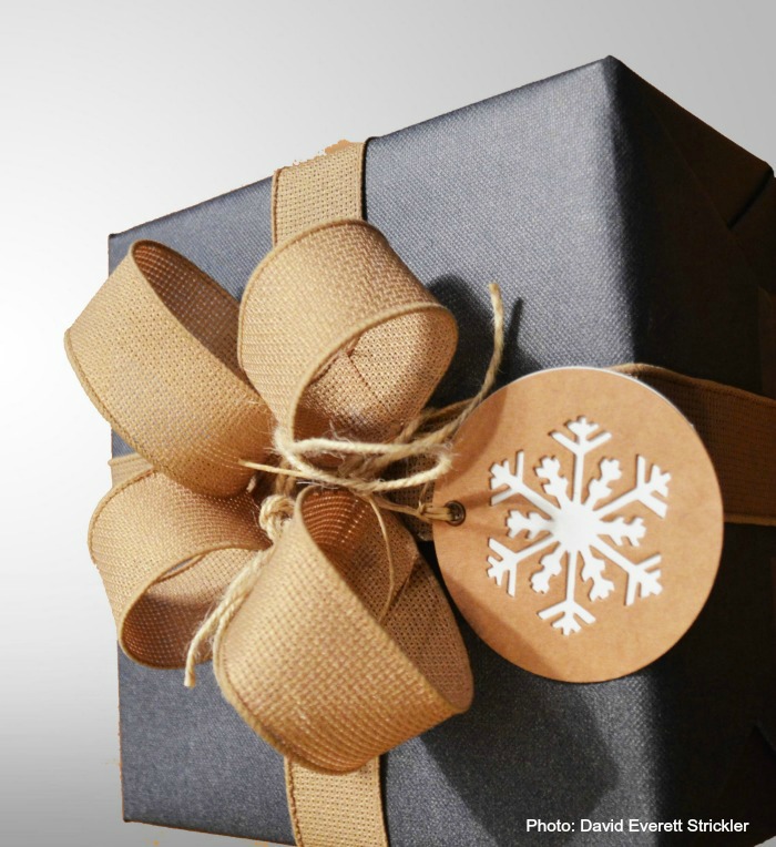 Blue wrapping paper with burlap ribbon and snowflake gift tag.