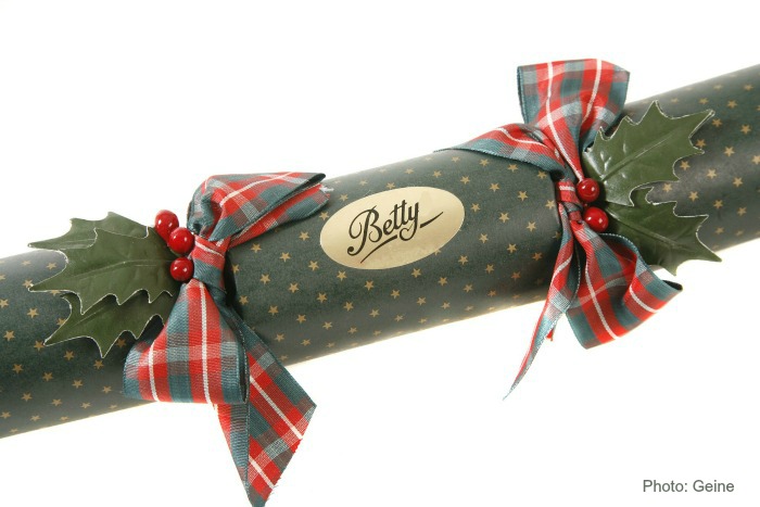 Wrapped cardboard tube. Cardboard tube wrapped with green paper, braided ribbon and personalized gold sticker.