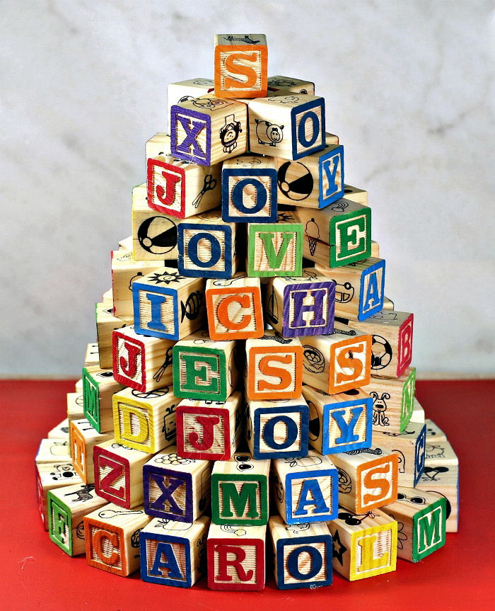 Finished alphabet block tree on a red base.