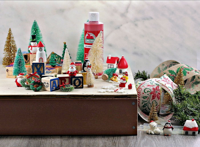 Supplies for the alphabet block Christmas tree. Paint, toys, blocks, ribbon and greenery for thealphabet blocks Christmas tree.