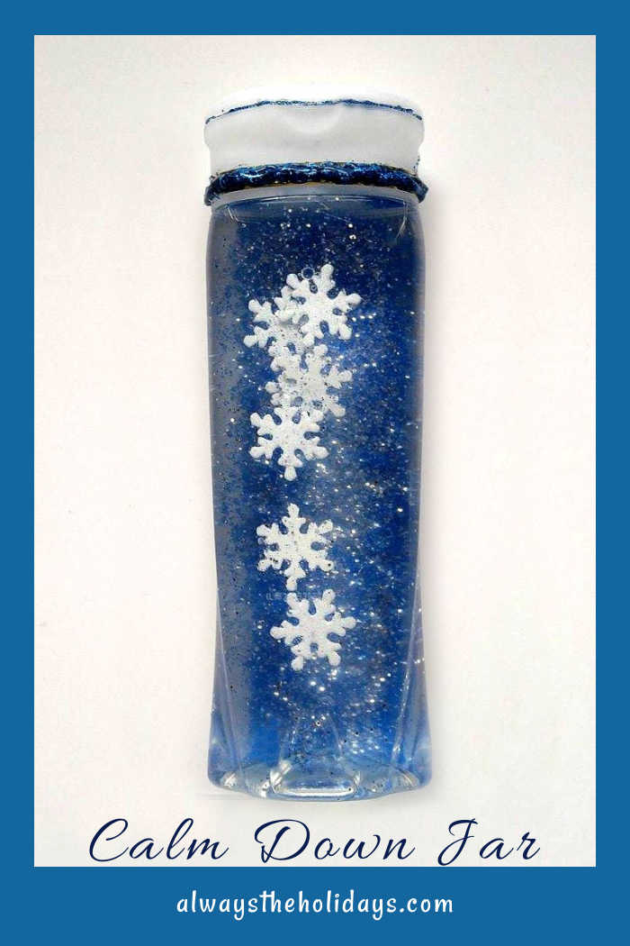 Blue bottle with snowflakes and glitter and words "calm down jar."