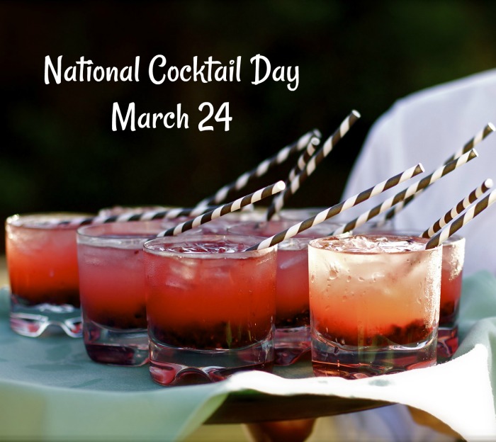 Cocktail tray with a National Cocktail Day text overlay. A tray of red cocktails with striped paper straws and a National Cocktail Day text overlay.