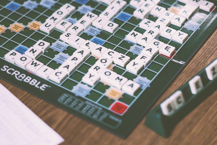 A scrabble game. A Scrabble game with the board mostly filled out.