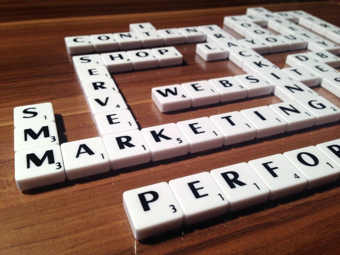Scrabble words. Words made with scrabble tiles on a wooden table.