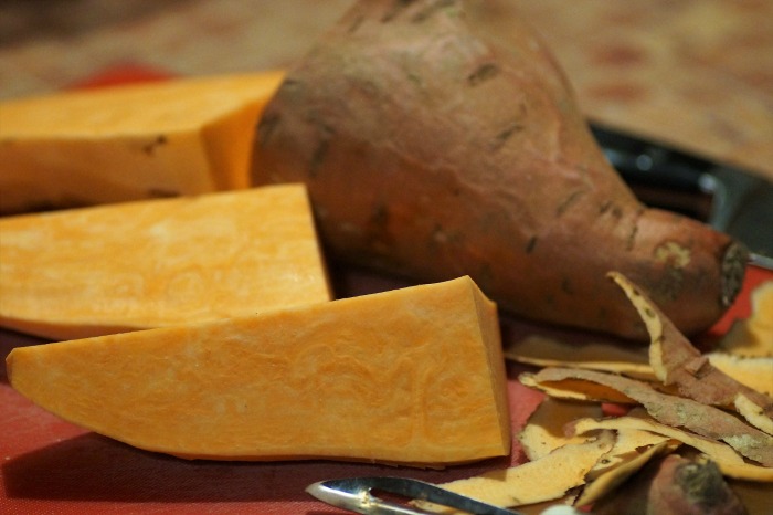 Sweet potato slices on a plate. A plate with sliced and peeled sweet potatoes on it to emphasize the many health benefits of sweet potatoes.