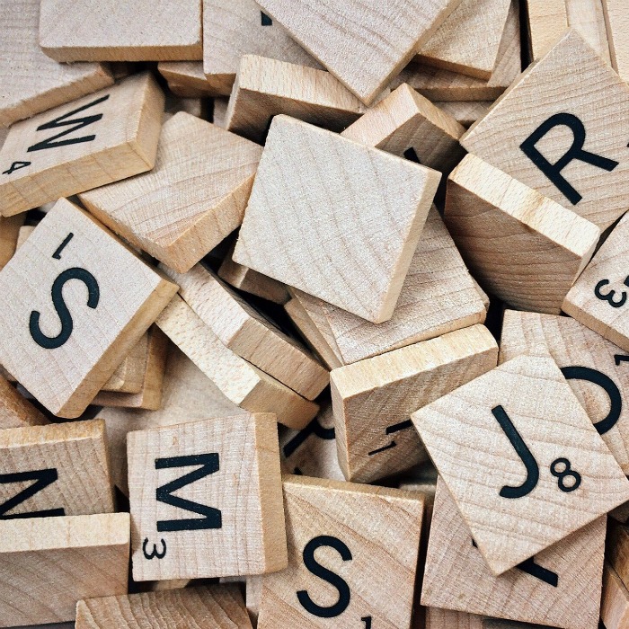 A pile of wooden scrabble tiles.