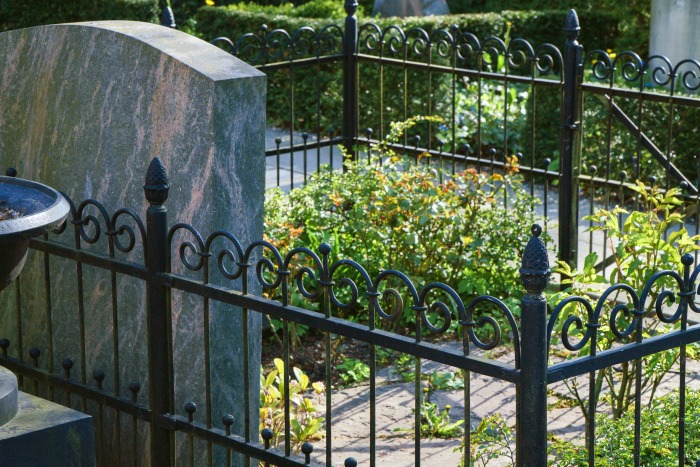 Gravestone picket fence Gravestone with a fence around it.