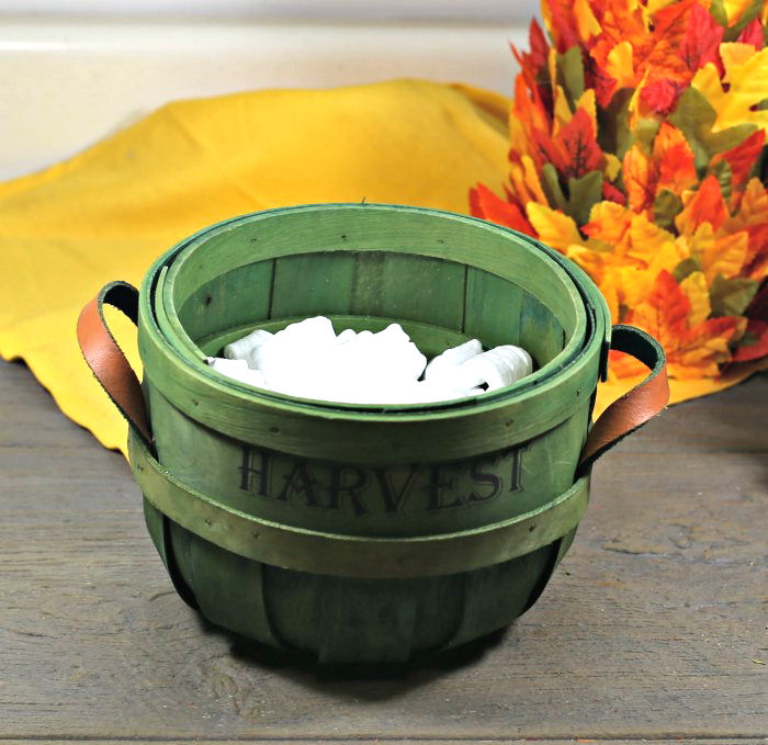 harvest basket with packing peanuts Harvest basket with packing peanuts near a yellow napkin and leaf tree.
