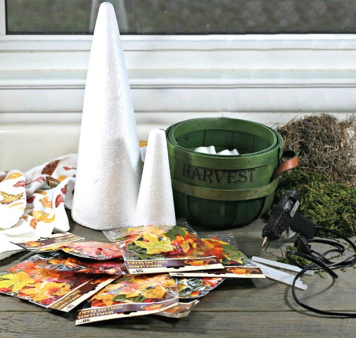 foam cones, basket, leaves and glue gun with moss Foam cones, basket, moss, seeds, glue gun and fall towel.