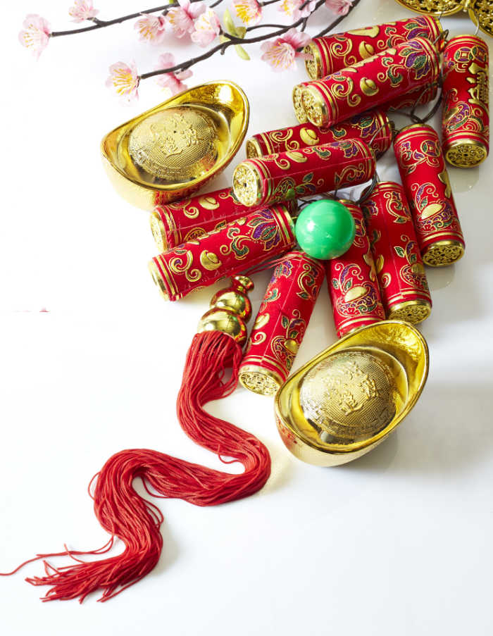 Red and gold Chinese New Year decorations. Firecrackers, cherry blossoms, and Red and gold Chinese New Year decorations.