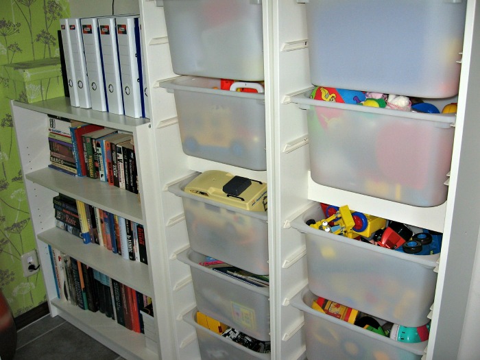 books in a bookcase and toys in clear bins Use transparent storage containers