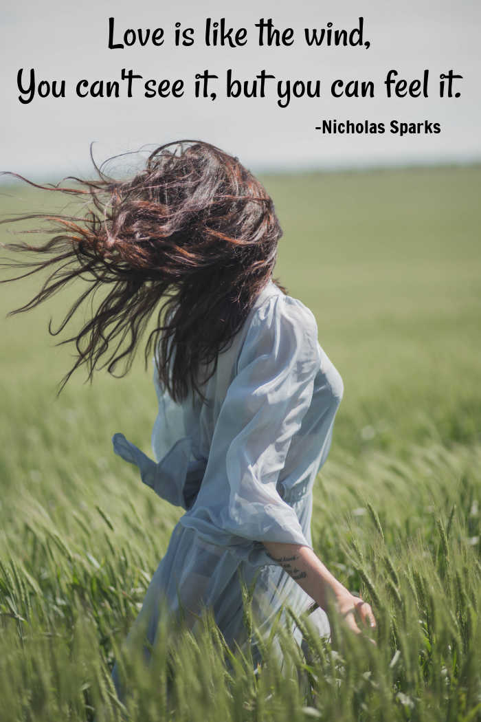 Inspirational love quote about the wind. Girl in a windy with love quote overlay.