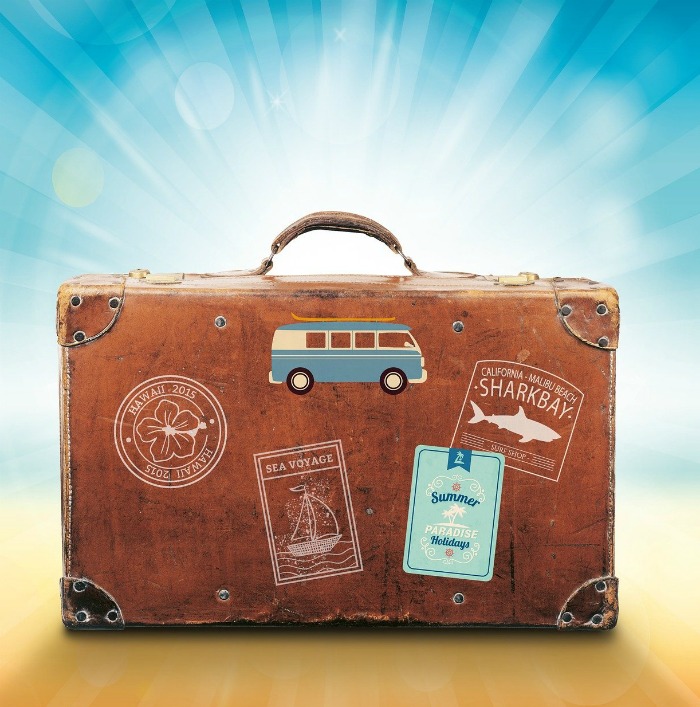 Suitcase with travel stickers on it.