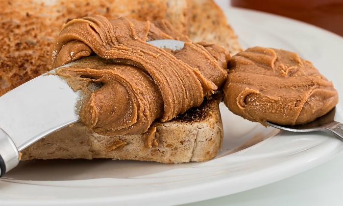 peanut butter on a knife and spoon