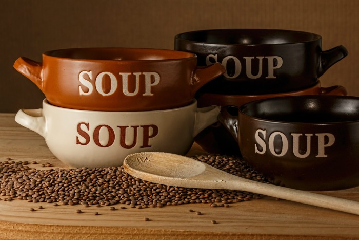 soup bowls, wooden spoon and lentils Soup bowls and lentils with a spoon