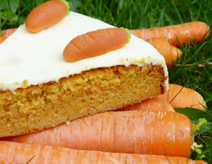 carrot cake slice on a pile of carrots Carrot cake on a pile of carrots