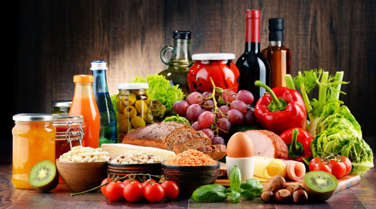 Spread of food and drink. Table filled with a variety of food and drink.