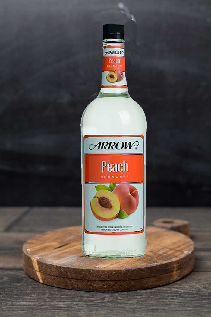 It's peach schnapps time! Bottle of peach schnapps on a wooden cutting board.