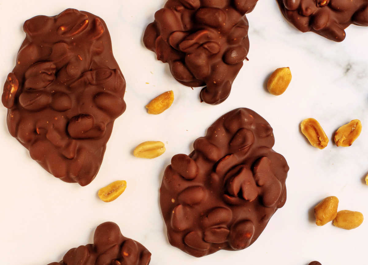 Peanut cluster day Peanut clusters and peanuts on a white background.