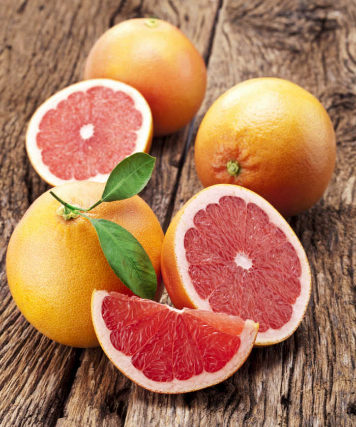 pink grapefruits. pink grapefruit, whole and cut.