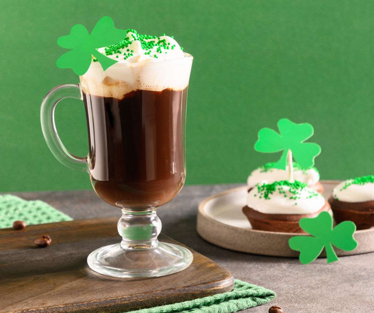 Let's celebrate St. Patrick's Day! Mug of Irish coffee, cupcake and shamrocks.