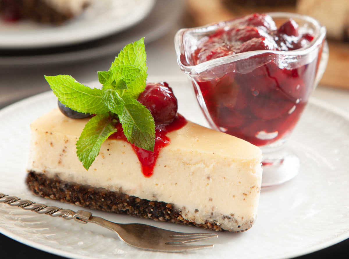 Cheesecake with jar of cherry syrup.