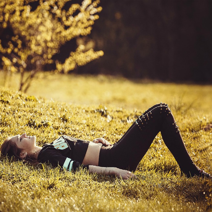 A woman laying on the grass.
