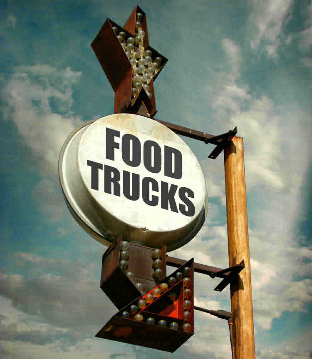 Lighted signs with arrow and words Food Trucks.