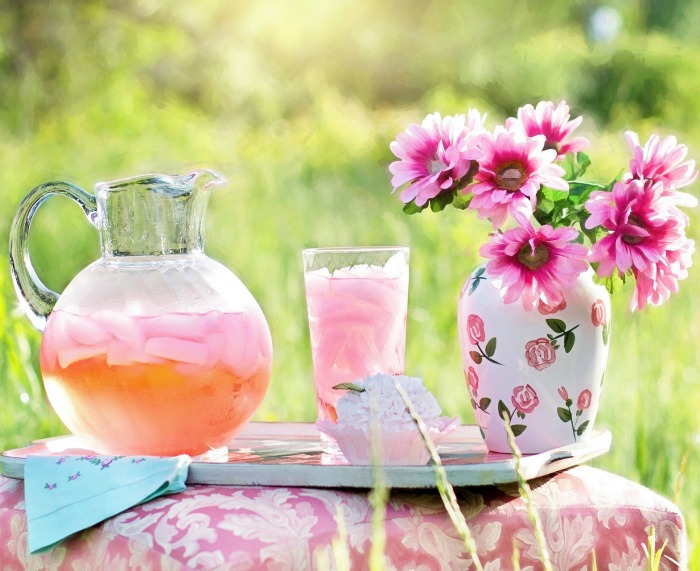 vase of flowers and jug and glass of pink lemonade Flowers and pink lemonade