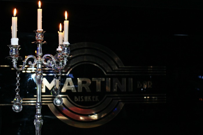 candelabra and candles with a martini sign The martini has been a popular drink for many generations