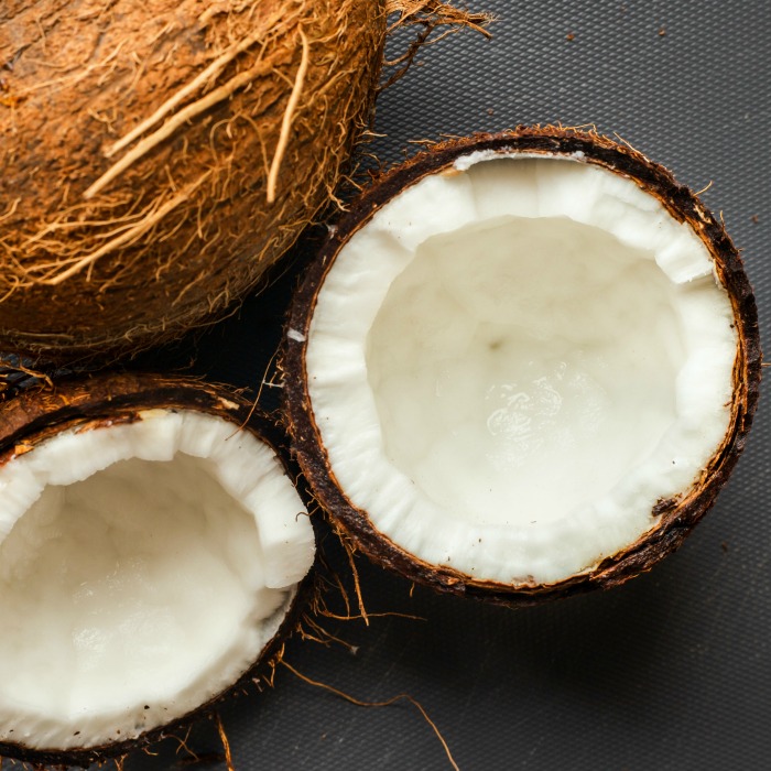 coconuts split with a whole coconut husk