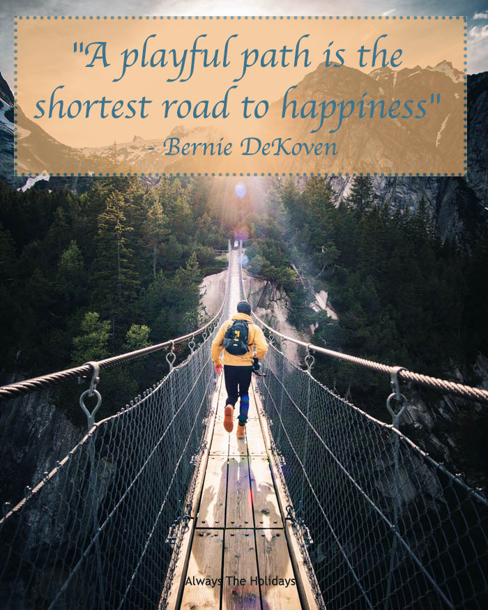 A man running on a hanging bridge towards a forest and mountains with a text overlay reading "A playful path is the shortest road to happiness" - Bernie DeKoven A playful path is the shortest road to happiness quote