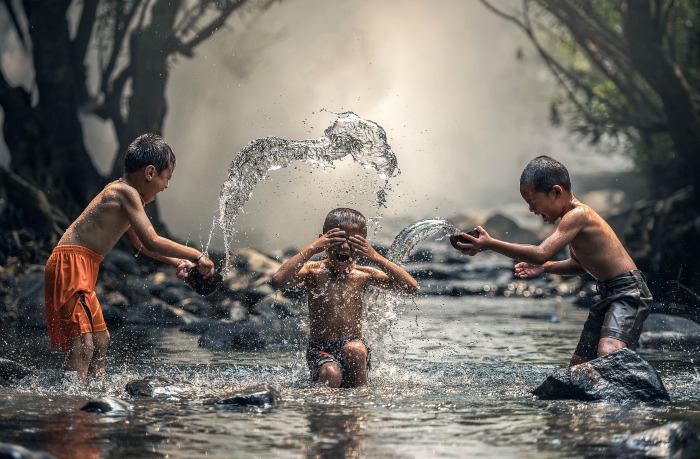 Be a kid again Day just like these Children playing in a brook