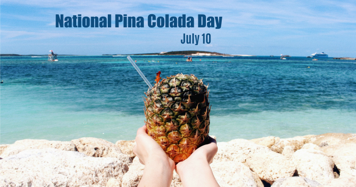 hands holding a coconut with a straw in it be the sea with the words National PIna Colada Day July 10 National Pina Colada Day is celebrated each year on July 10