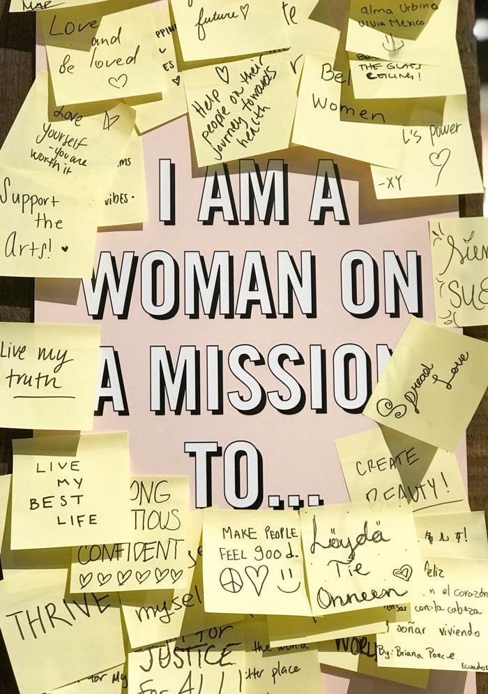 post it notes filled with quotes and affirmation stuck on a board that reads I am a woman on a mission to... lots of quotes