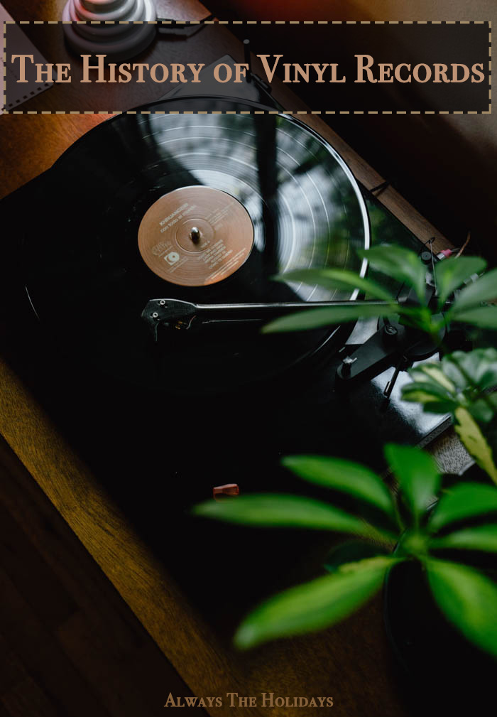 a record on a turntable next to a plant with a text overlay reading the history of vinyl records the history of vinyl records