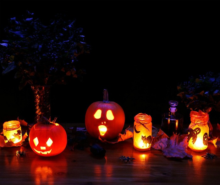 luminaries made of plastic pumpkins and Mason Jars with lights inside Halloween luminaries