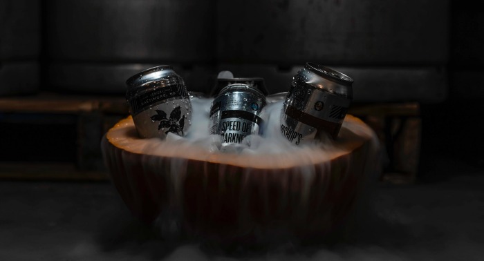 drinks and dry ice in a cut out pumpkin Setting a spooky mood for a Halloween party