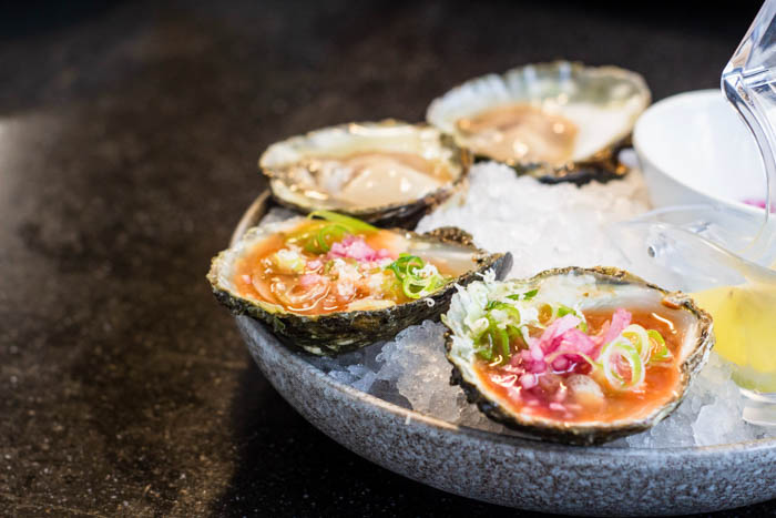 A raw oyster appetizer, garnished and ready to eat Raw oyster appetizer