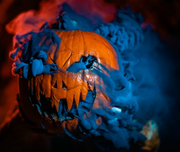 carved Jack O Lantern with blue fog flowing out Pumpkin with blue fog flowing out