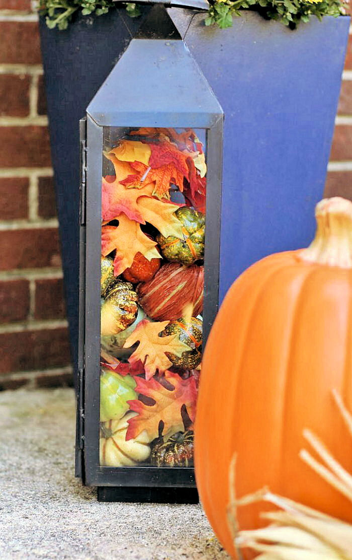 DIY fall decor ideas - Lantern filled with pumpkins and leaves